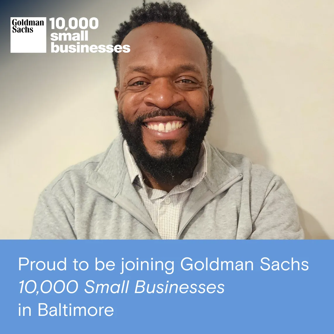 Smiling man in front of Goldman Sachs 10,000 Small Businesses logo — Best Fit Digital founder